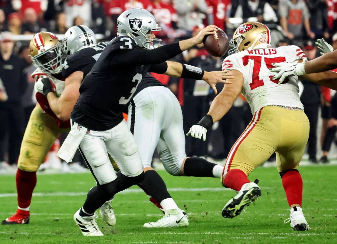 Raiders quarterback Jarrett Stidham (3) looks to pass under pressure from San Francisco 49ers d ...