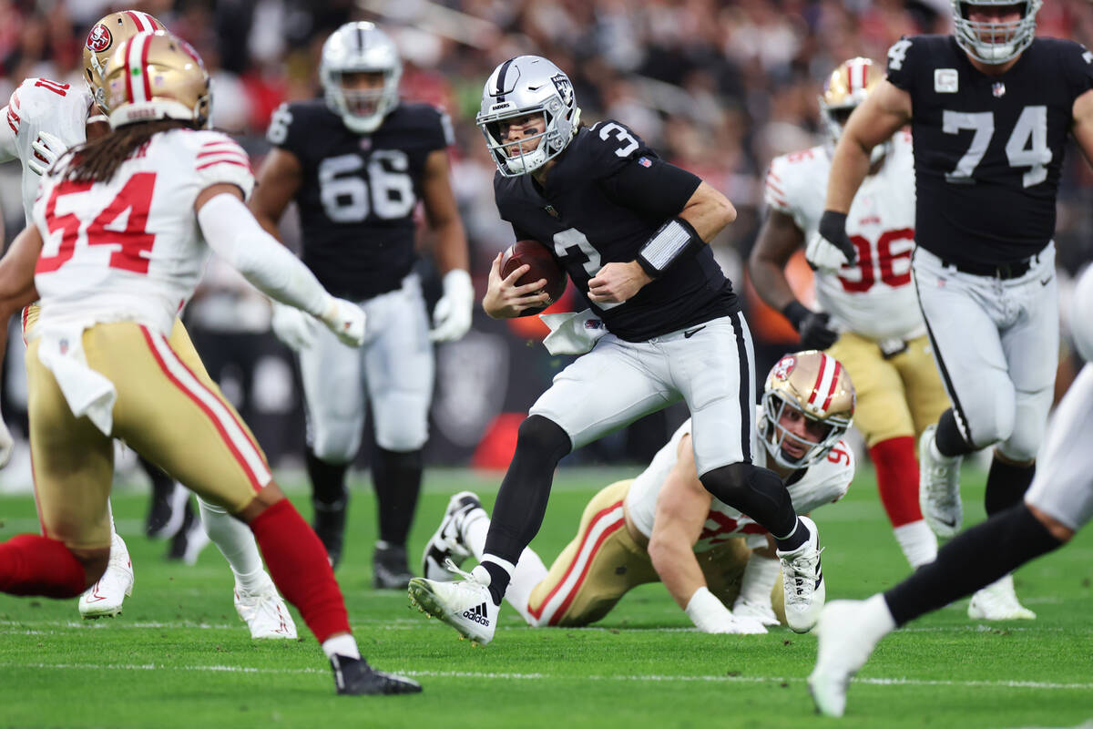 Raiders quarterback Jarrett Stidham (3) runs the ball during the first half of a NFL football g ...