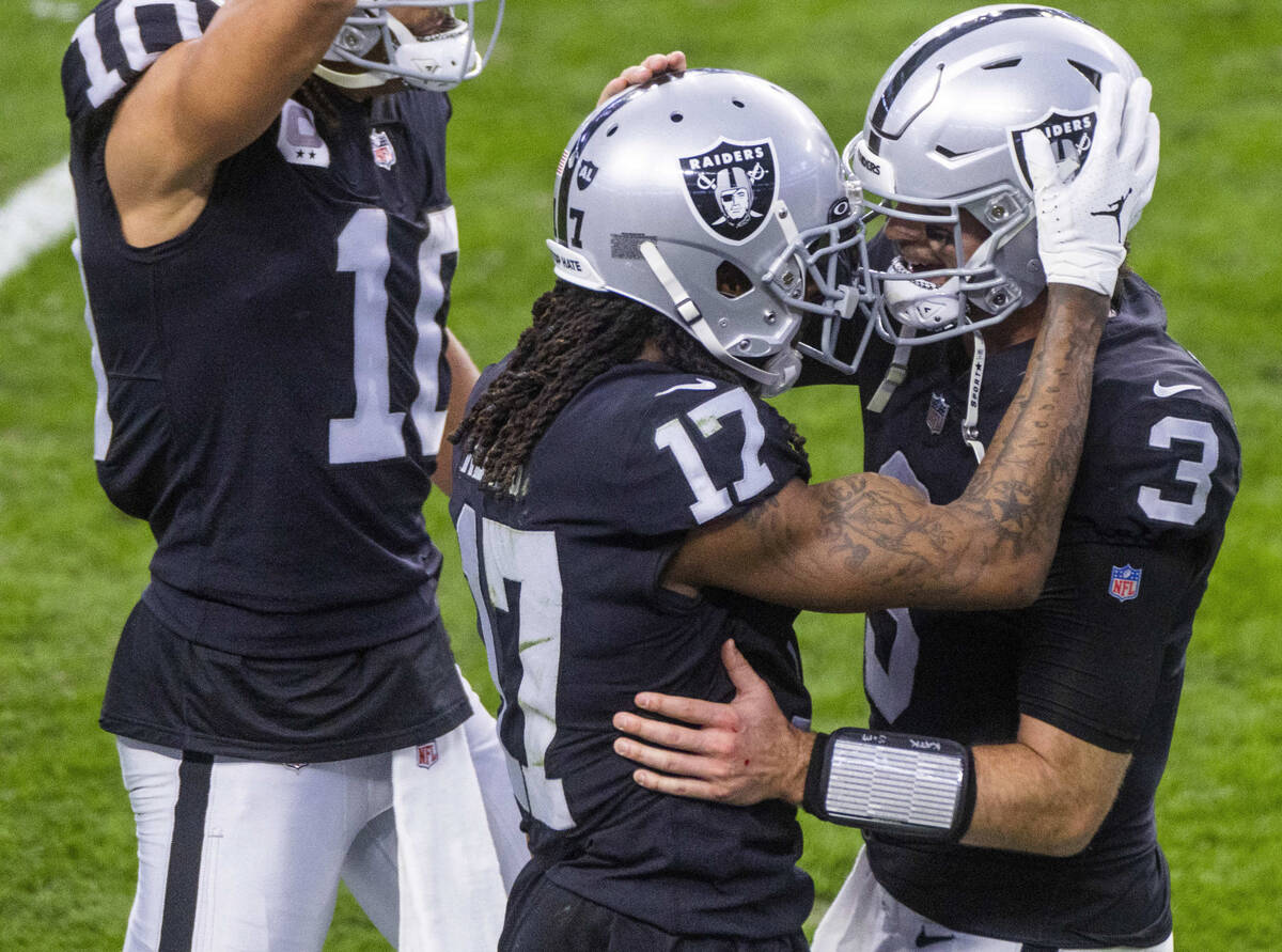 Raiders quarterback Jarrett Stidham (3) celebrates a touchdown with teammate wide receiver Dava ...