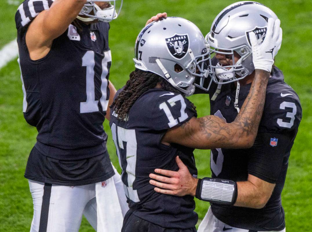 Raiders quarterback Jarrett Stidham (3) celebrates a touchdown with teammate wide receiver Dava ...