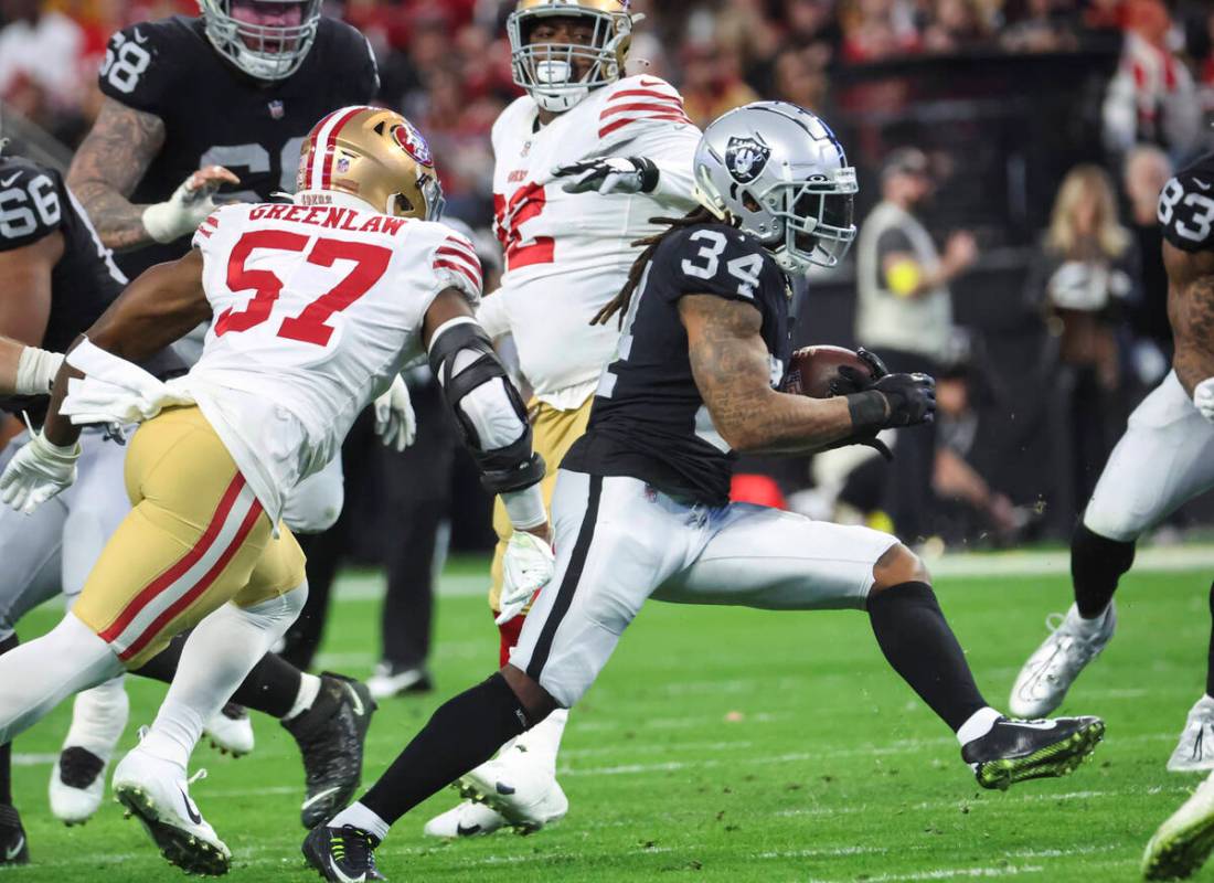 Raiders running back Brandon Bolden (34) runs the ball during the first half of an NFL game aga ...