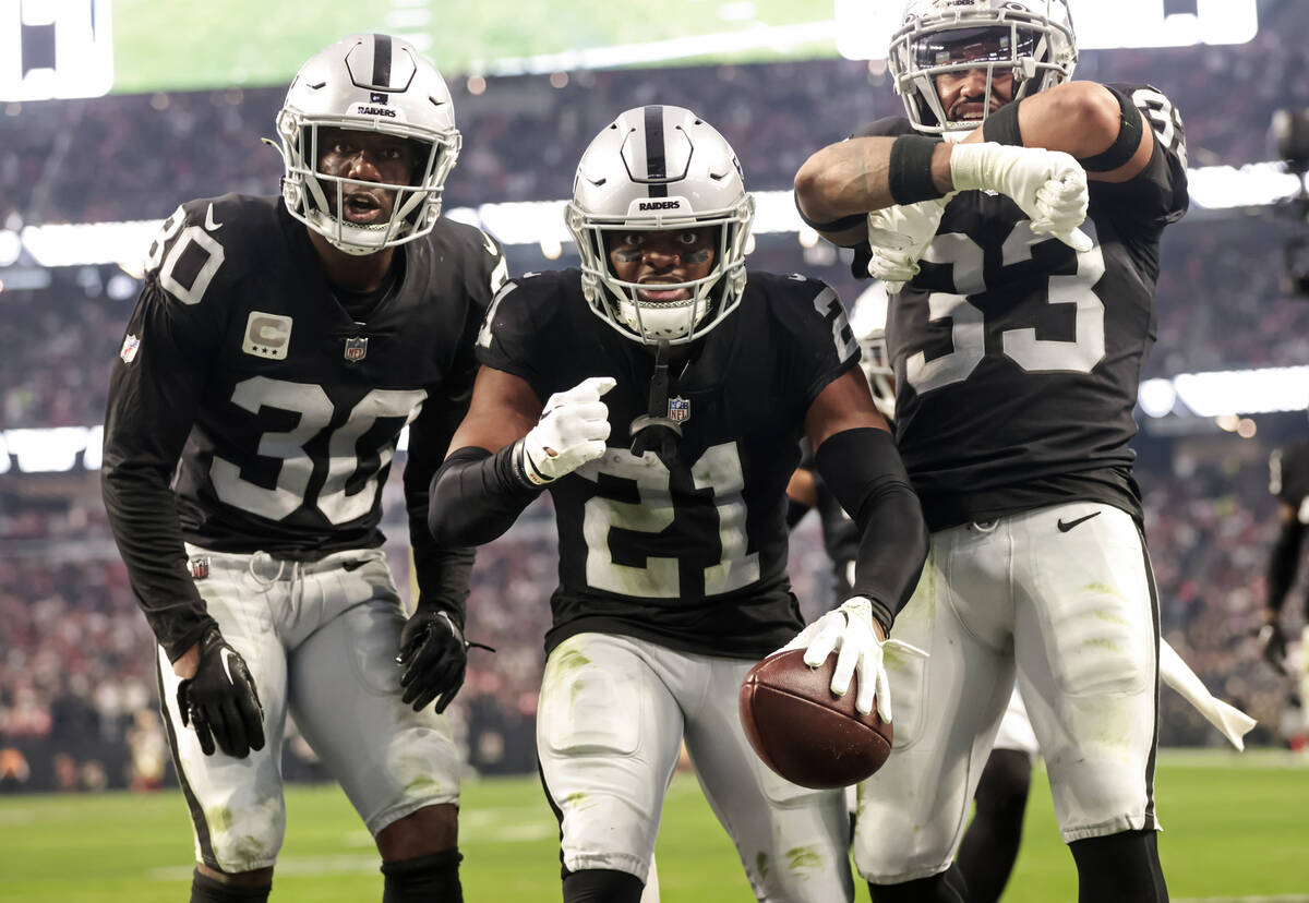 Raiders cornerback Amik Robertson (21) celebrates his interception with safeties Duron Harmon ( ...