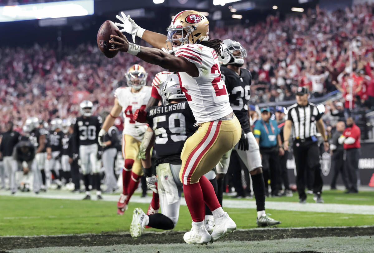 San Francisco 49ers running back Jordan Mason scores a touchdown against the Raiders during the ...