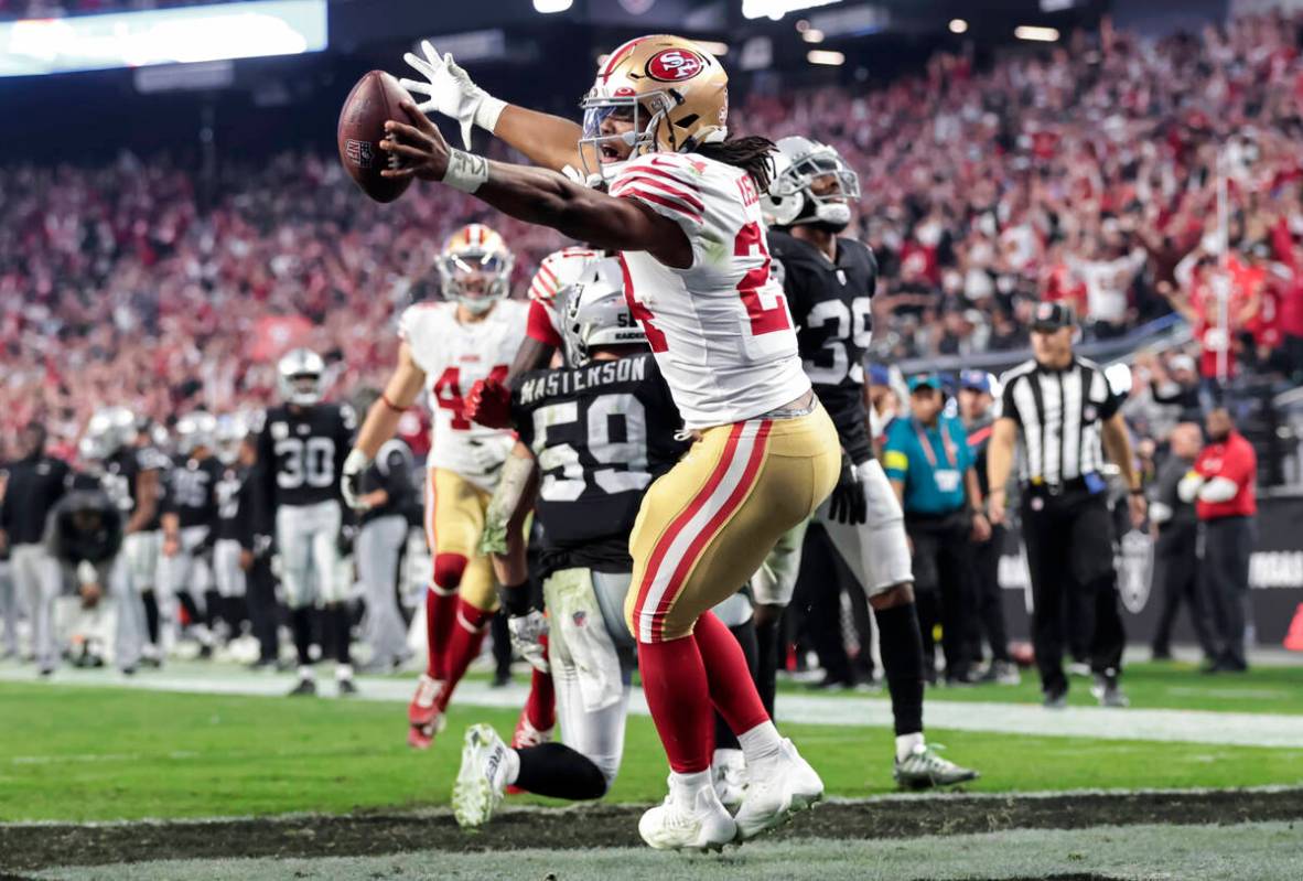 San Francisco 49ers running back Jordan Mason scores a touchdown against the Raiders during the ...