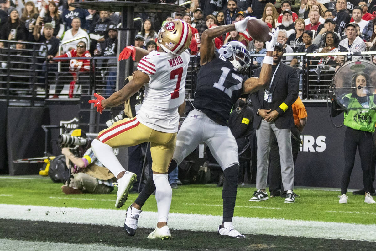 Raiders wide receiver Davante Adams (17) scores a touchdown with San Francisco 49ers cornerback ...