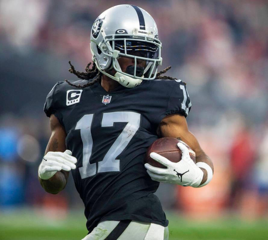 Raiders wide receiver Davante Adams (17) looks back as he runs into the end zone for a touchdow ...