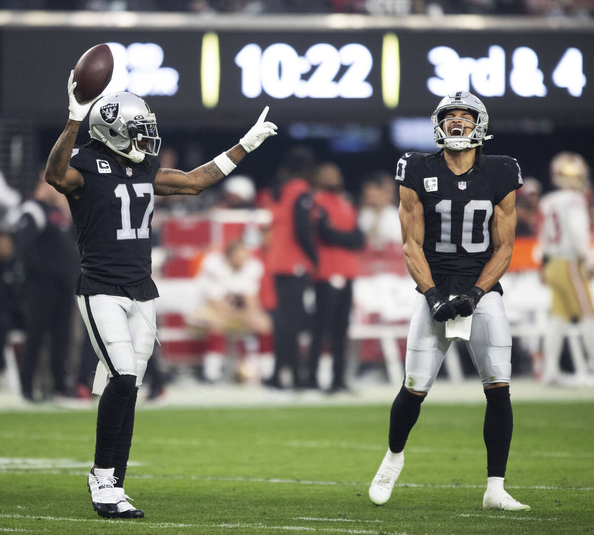 Raiders wide receiver Davante Adams (17) celebrate a touchdown with wide receiver Mack Hollins ...