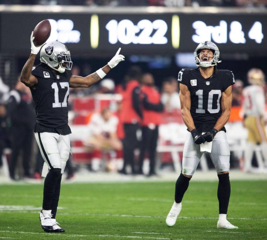 Raiders wide receiver Davante Adams (17) celebrate a touchdown with wide receiver Mack Hollins ...