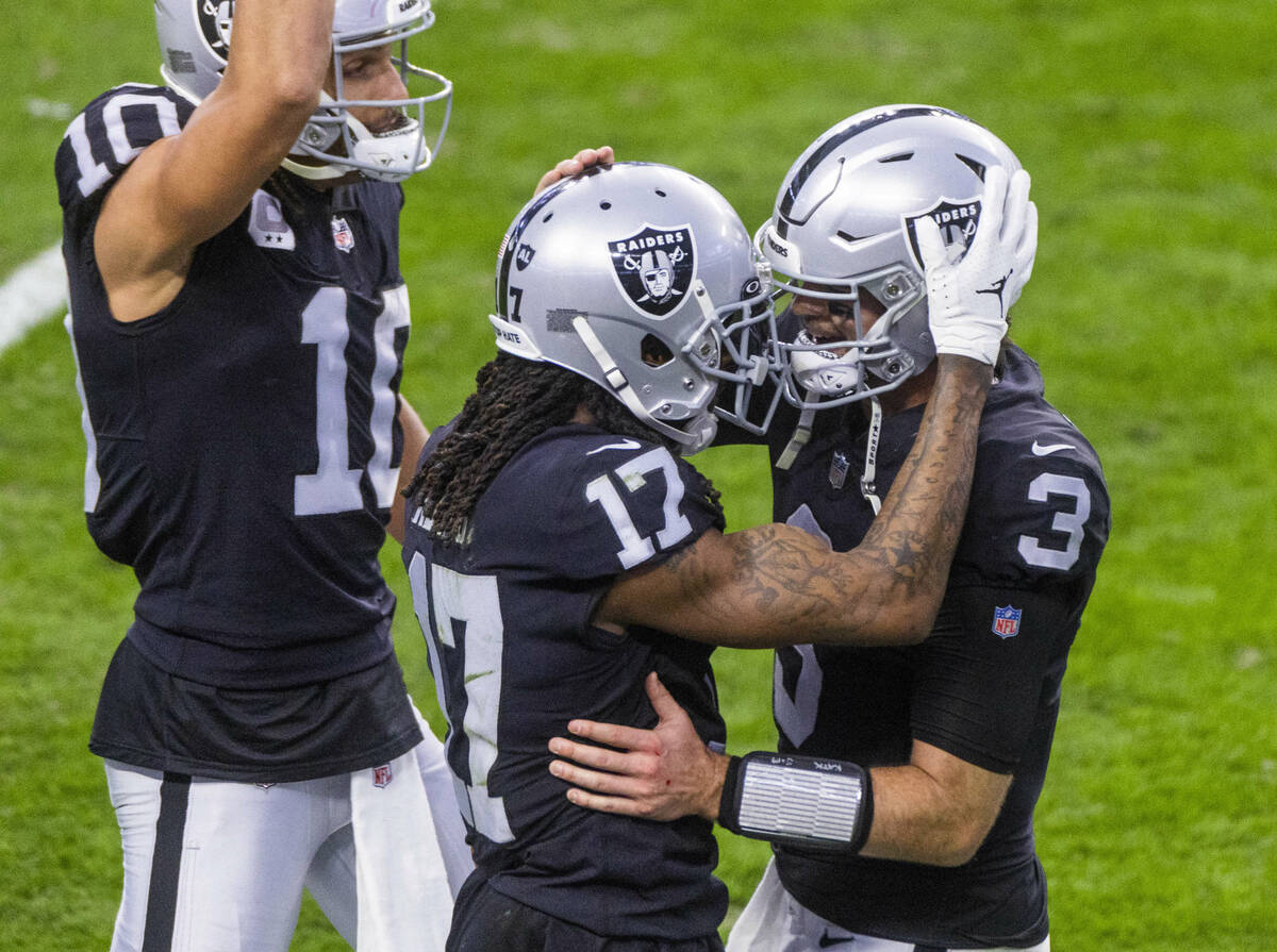 Raiders quarterback Jarrett Stidham (3) celebrates a touchdown with teammate wide receiver Dava ...