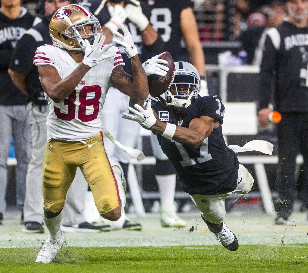 Raiders wide receiver Davante Adams (17) grabs a long pass over San Francisco 49ers cornerback ...