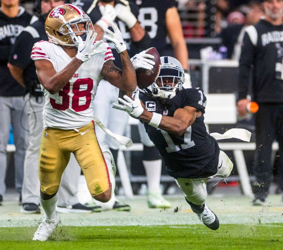 Raiders wide receiver Davante Adams (17) grabs a long pass over San Francisco 49ers cornerback ...