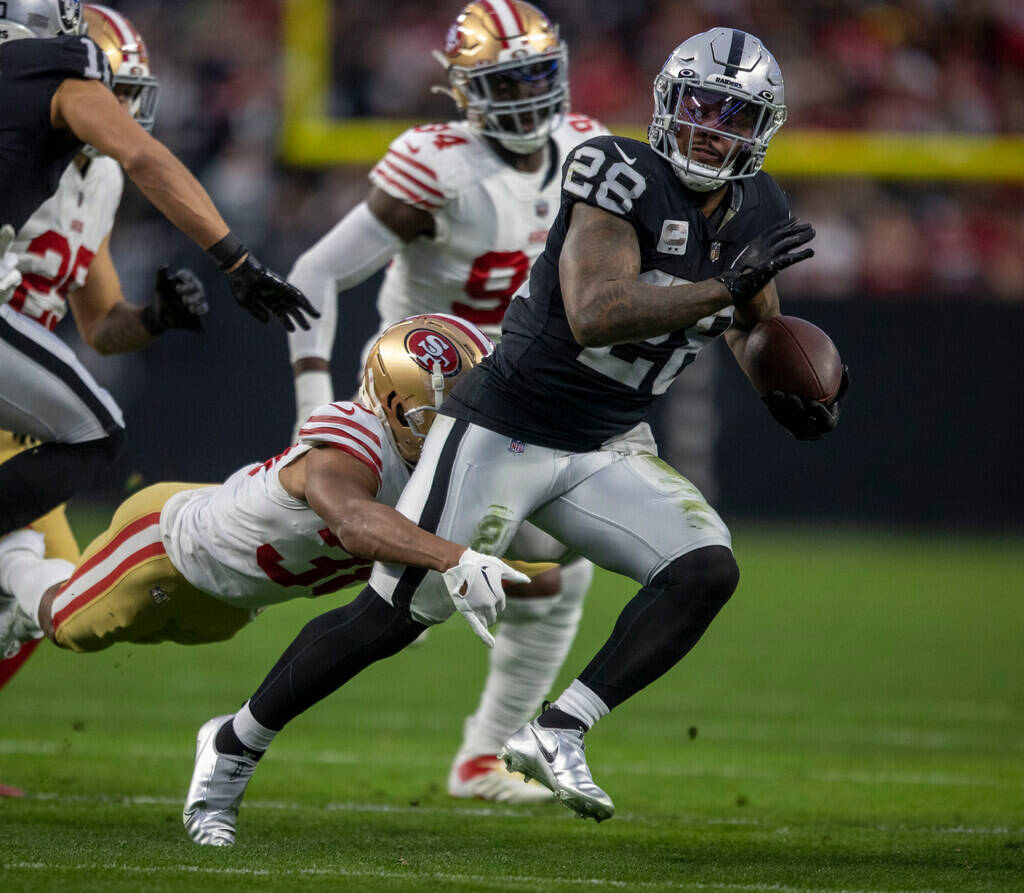 Raiders running back Josh Jacobs (28) runs as San Francisco 49ers cornerback Deommodore Lenoir ...