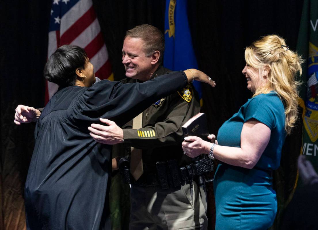 Sheriff Kevin McMahill hugs Judge Tierra Jones after being sworn in as LVMPD Sheriff as his wif ...