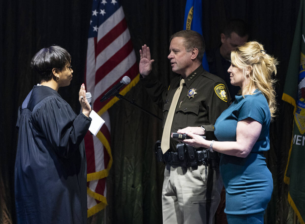 Sheriff Kevin McMahill raises his arm as he is sworn in by Judge Tierra Jones as LVMPD Sheriff ...