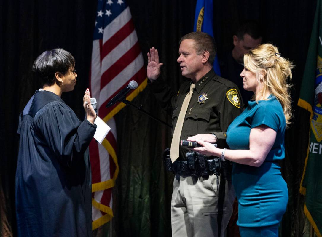 Sheriff Kevin McMahill raises his arm as he is sworn in by Judge Tierra Jones as LVMPD Sheriff ...