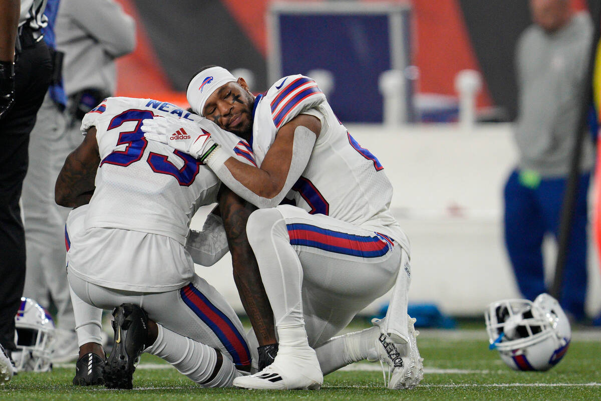 Buffalo Bills' Siran Neal (33) and Nyheim Hines react after teammate Damar Hamlin was injured d ...