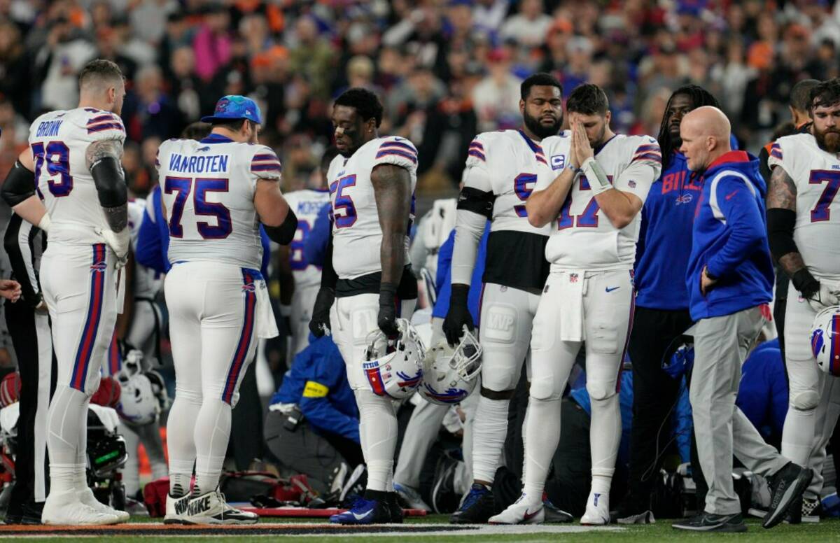 Buffalo Bills quarterback Josh Allen (17) pauses as Damar Hamlin is examined during the first h ...