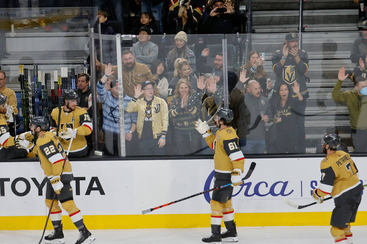 Golden Knights center Michael Amadio (22) celebrates with Golden Knights right wing Mark Stone ...