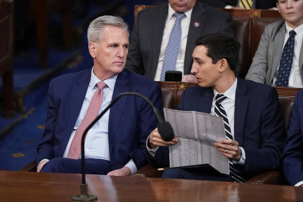 Rep. Kevin McCarthy of Calif., talks to an aide as he listens as votes are cast for next Speake ...