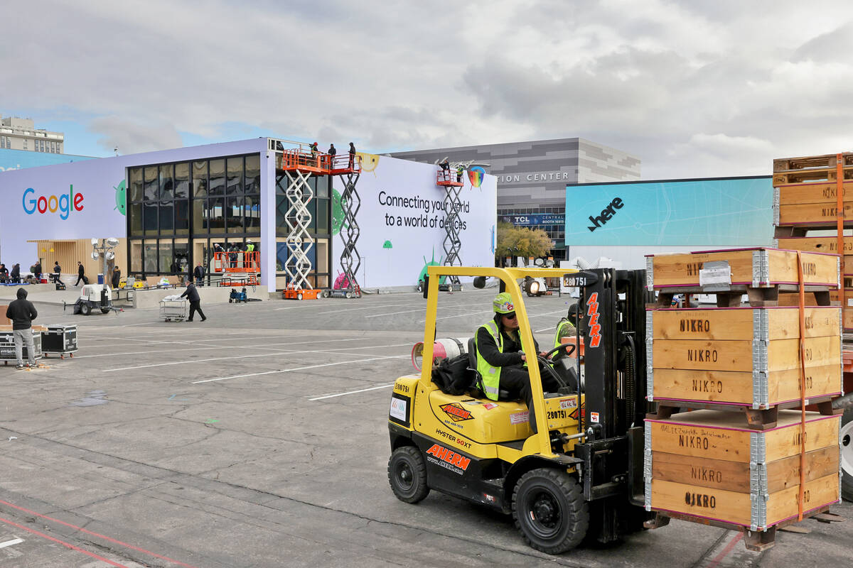 Workers build outdoor booths for CES at the Las Vegas Convention Center Tuesday, Jan. 3, 2023. ...