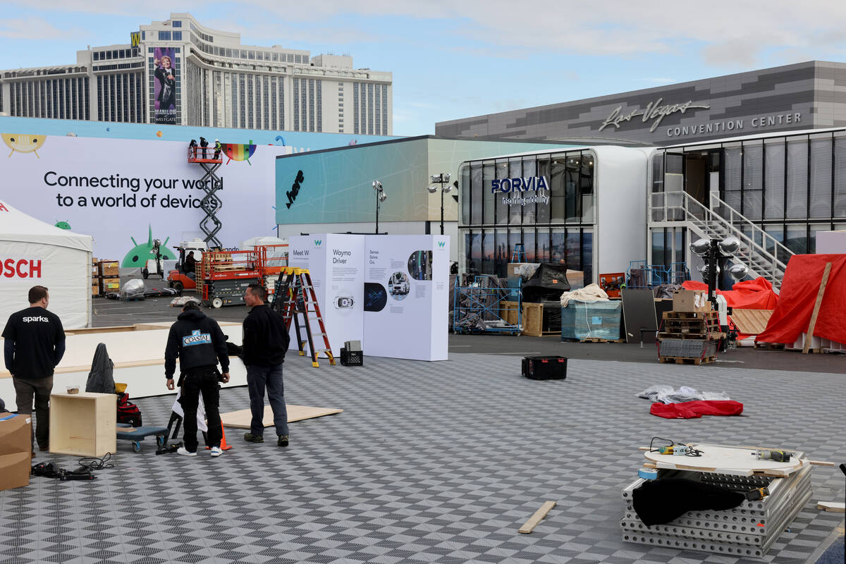 Workers build outdoor booths for CES at the Las Vegas Convention Center Tuesday, Jan. 3, 2023. ...