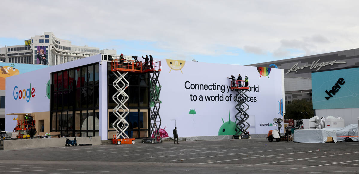 Workers build outdoor booths for CES at the Las Vegas Convention Center Tuesday, Jan. 3, 2023. ...