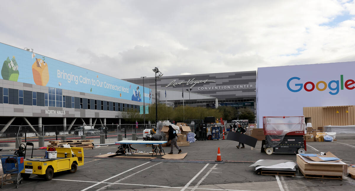 Workers build outdoor booths for CES at the Las Vegas Convention Center Tuesday, Jan. 3, 2023. ...