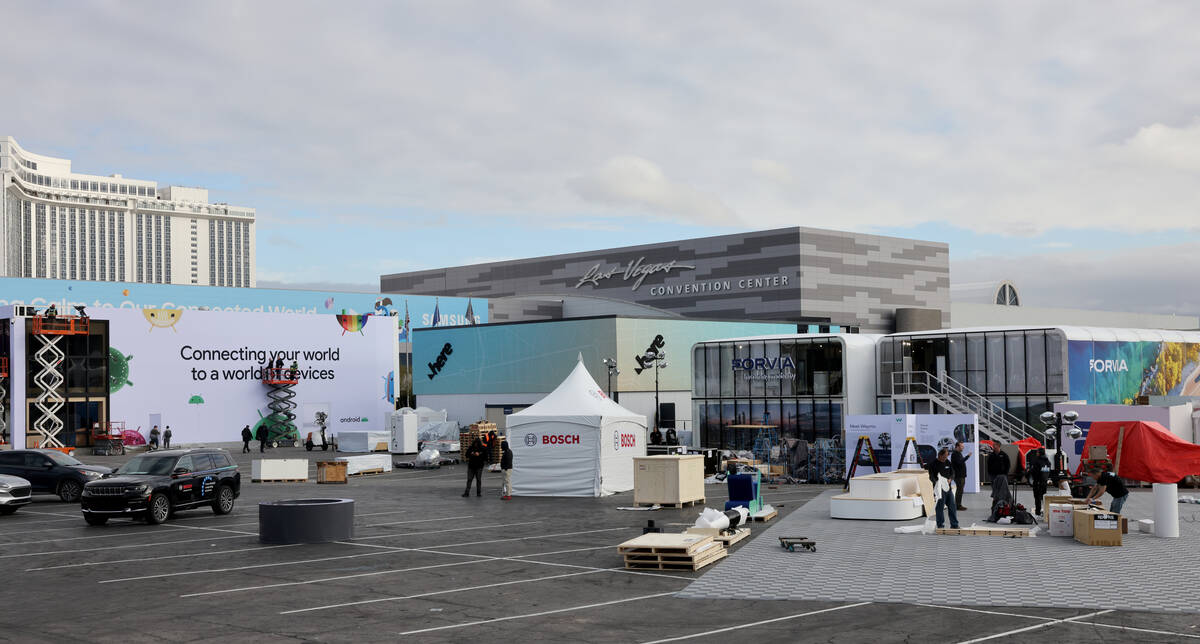 Workers build outdoor booths for CES at the Las Vegas Convention Center Tuesday, Jan. 3, 2023. ...