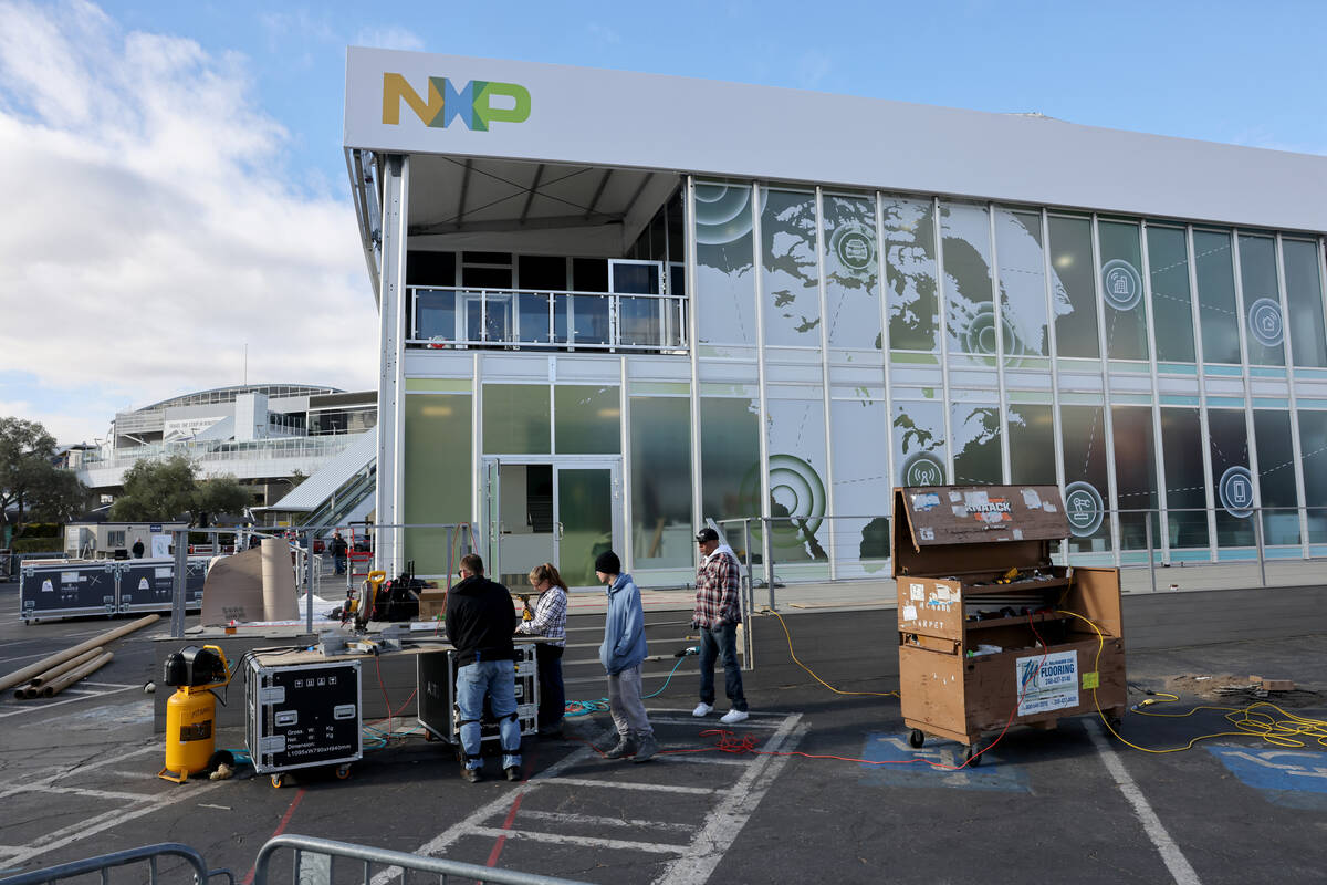 Workers build outdoor booths for CES at the Las Vegas Convention Center Tuesday, Jan. 3, 2023. ...