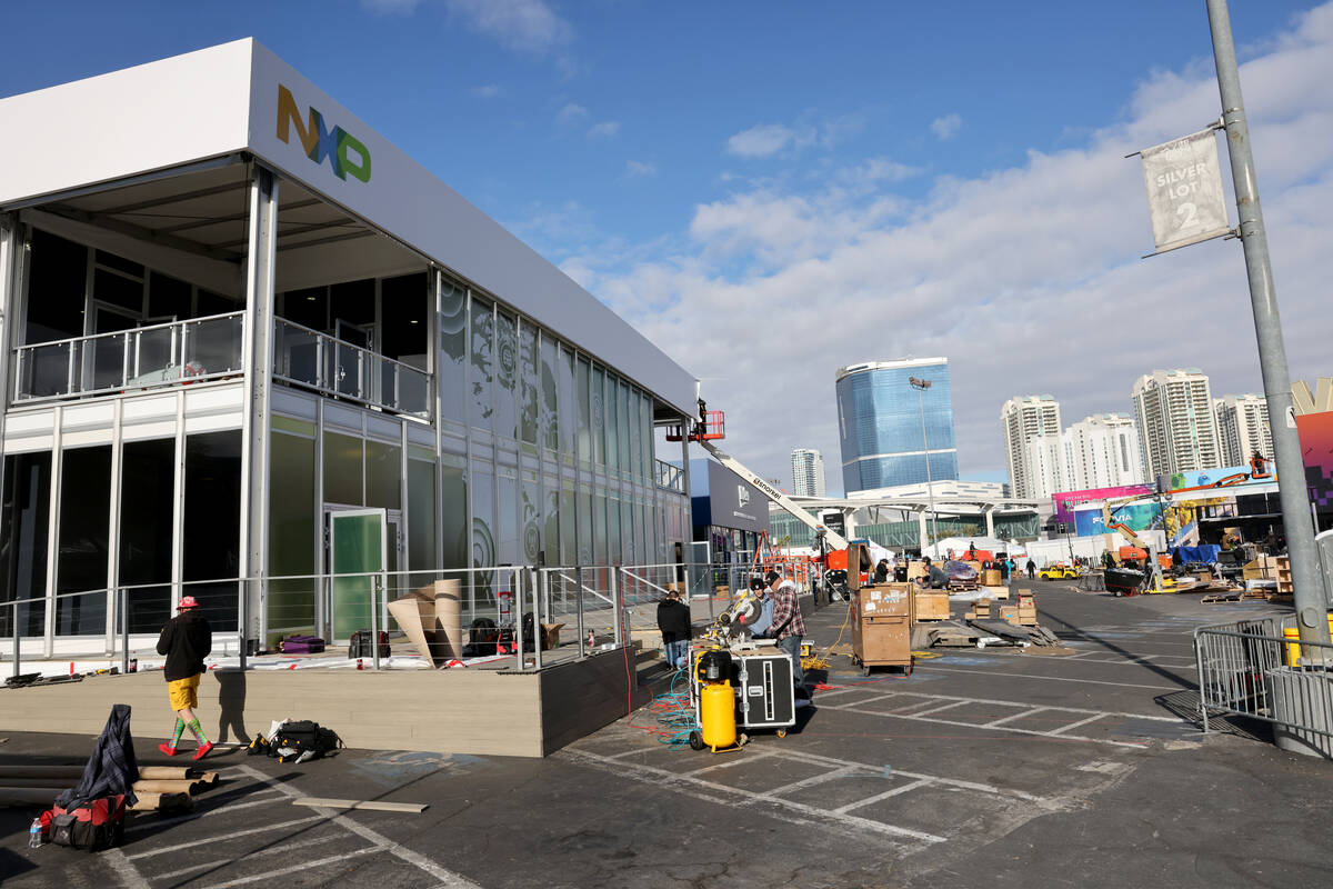 Workers build outdoor booths for CES at the Las Vegas Convention Center Tuesday, Jan. 3, 2023. ...