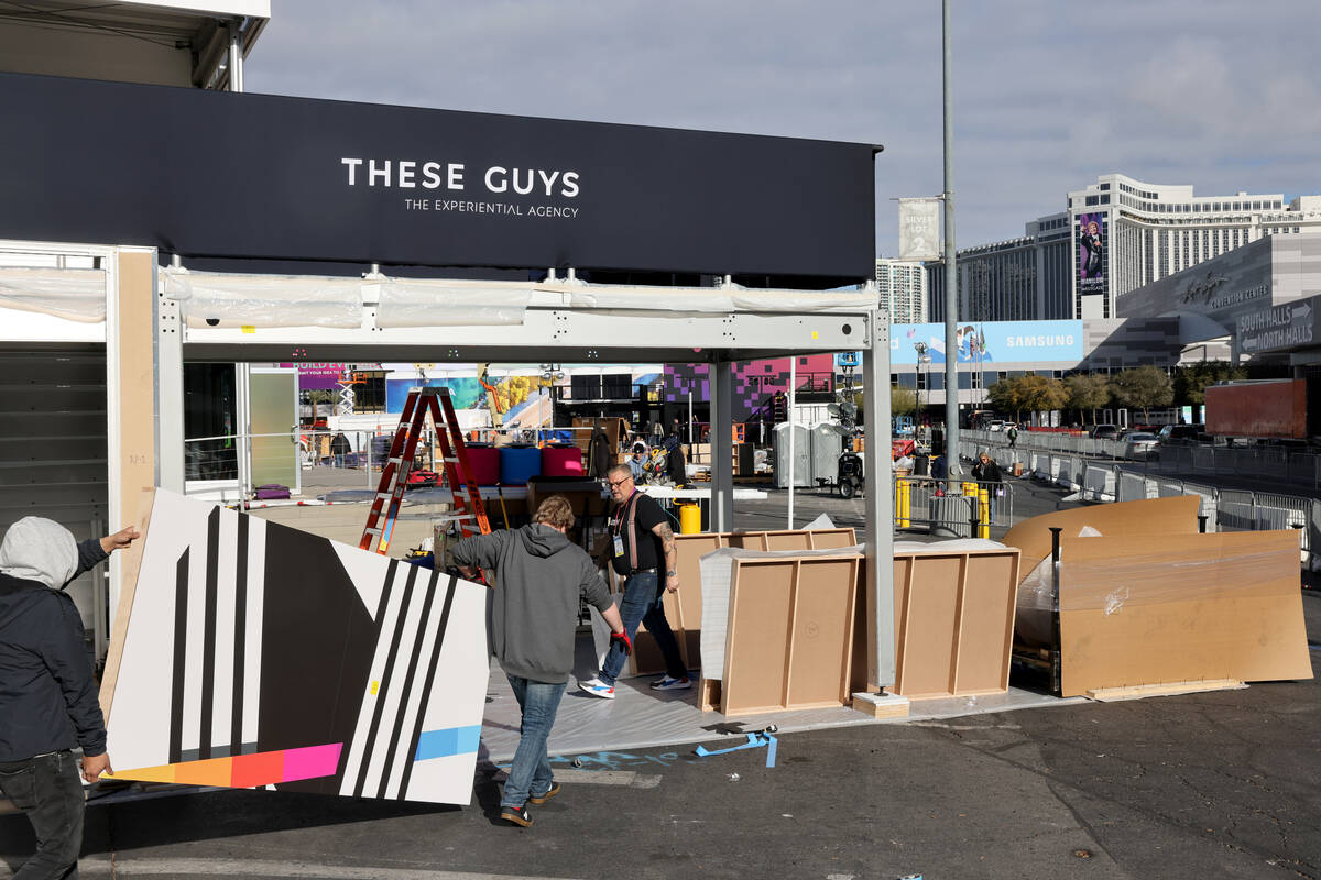 Workers build outdoor booths for CES at the Las Vegas Convention Center Tuesday, Jan. 3, 2023. ...