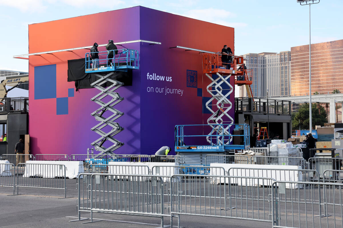 Workers build outdoor booths for CES at the Las Vegas Convention Center Tuesday, Jan. 3, 2023. ...