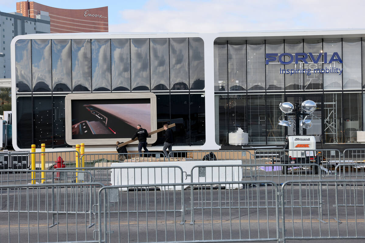 Workers build outdoor booths for CES at the Las Vegas Convention Center Tuesday, Jan. 3, 2023. ...