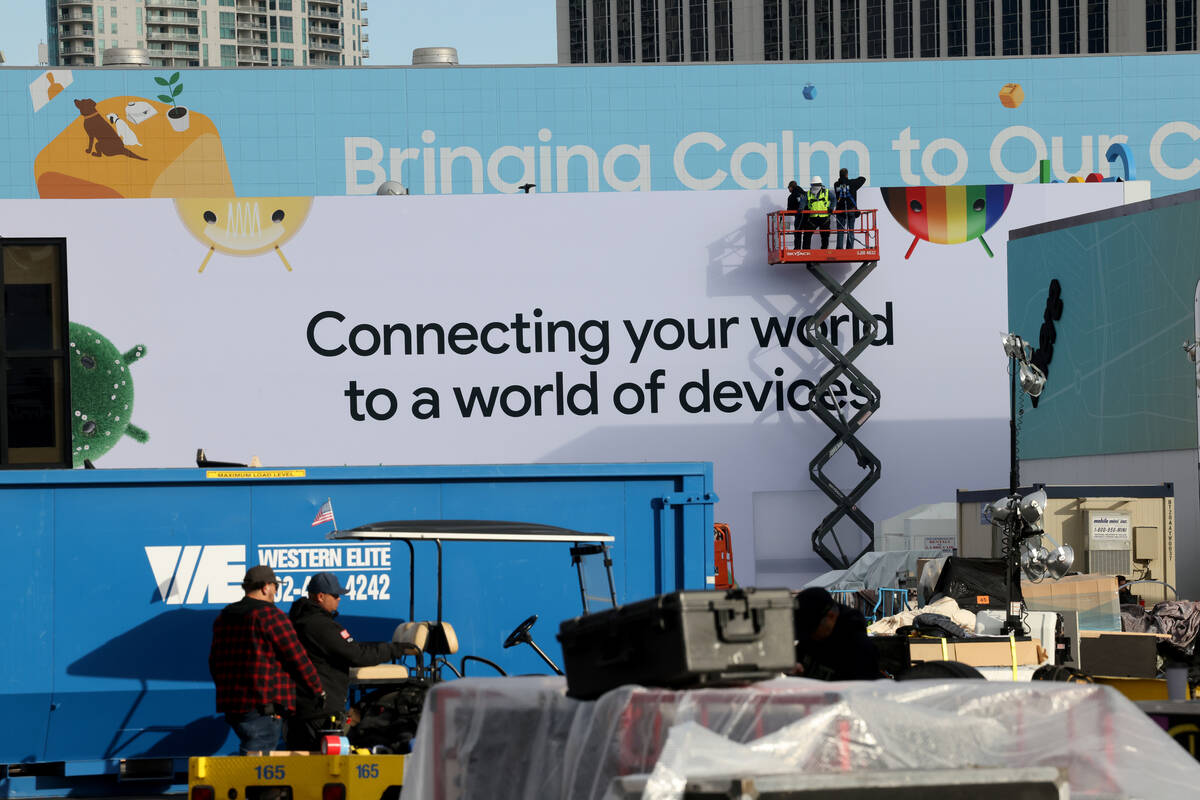 Workers build outdoor booths for CES at the Las Vegas Convention Center Tuesday, Jan. 3, 2023. ...