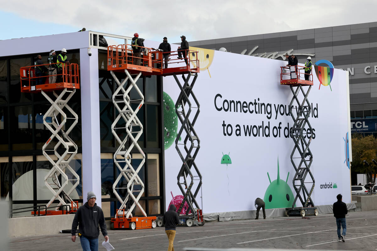 Workers build outdoor booths for CES at the Las Vegas Convention Center Tuesday, Jan. 3, 2023. ...