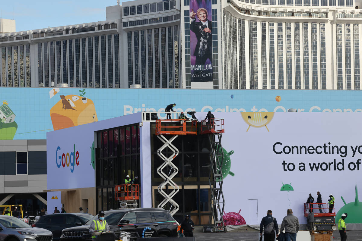 Workers build outdoor booths for CES at the Las Vegas Convention Center Tuesday, Jan. 3, 2023. ...