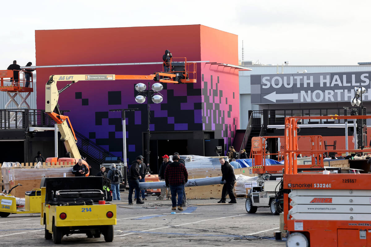 Workers build outdoor booths for CES at the Las Vegas Convention Center Tuesday, Jan. 3, 2023. ...