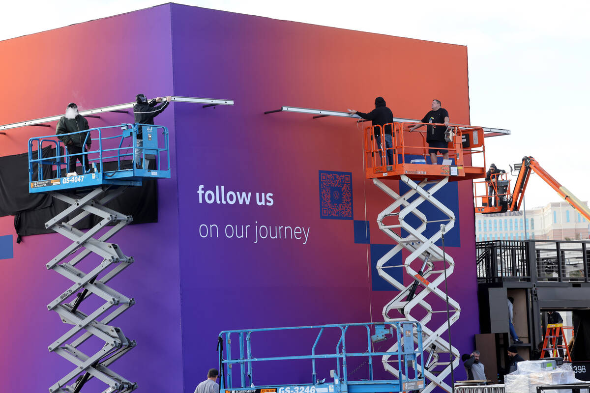 Workers build outdoor booths for CES at the Las Vegas Convention Center Tuesday, Jan. 3, 2023. ...