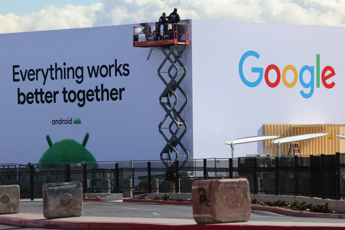 Workers build outdoor booths for CES at the Las Vegas Convention Center Tuesday, Jan. 3, 2023. ...