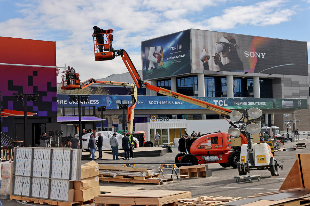 Workers build outdoor booths for CES at the Las Vegas Convention Center Tuesday, Jan. 3, 2023. ...