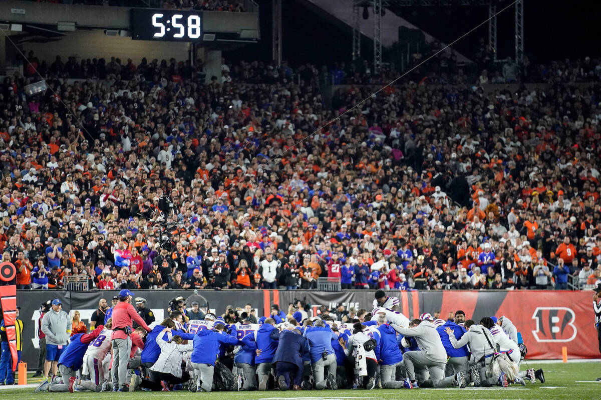 Buffalo Bills players and staff pray for Buffalo Bills' Damar Hamlin during the first half of a ...