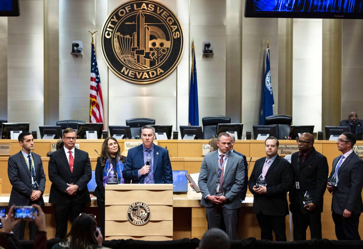 Metro Lt. Jason Johansson speaks as Councilwoman Victoria Seaman, third left, and the team of M ...