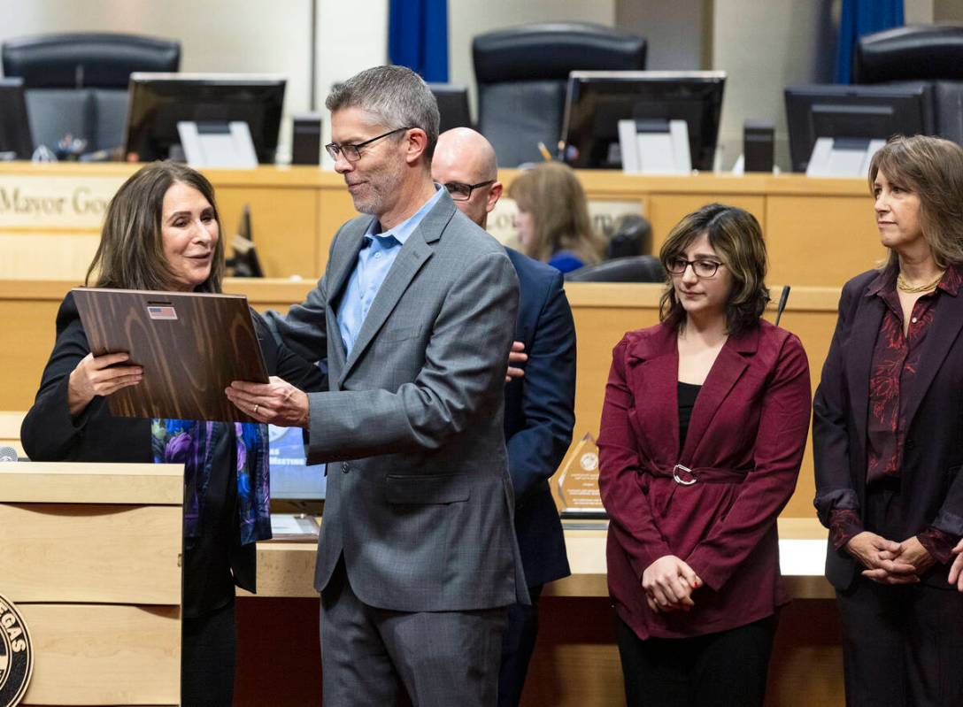 Councilwoman Victoria Seaman, presents a proclamation to Glenn Cook, executive editor and senio ...