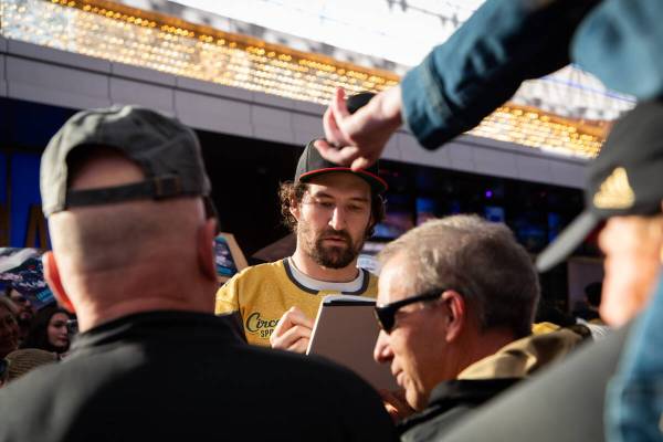 Las Vegas Golden Knights’ Mark Stone signs autographs during the Fan Fest at the Fremont ...