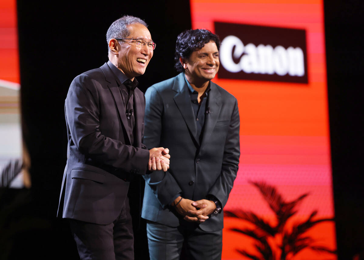 Kazuto “Kevin” Ogawa, president and CEO of Canon Americas, left, and M. Night Shyamalan, wh ...