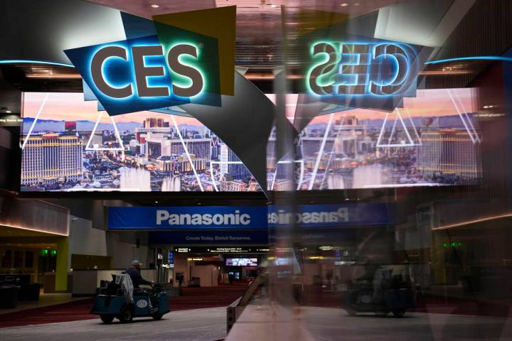 A worker drives down a hallway during preparations at the Las Vegas Convention Center before th ...