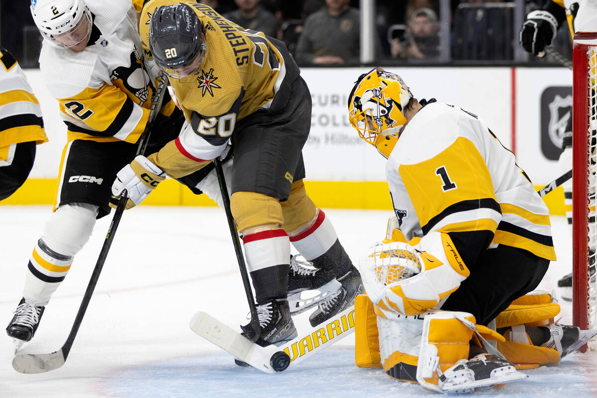 Vegas Golden Knights center Chandler Stephenson (20) and Pittsburgh Penguins defenseman Chad Ru ...