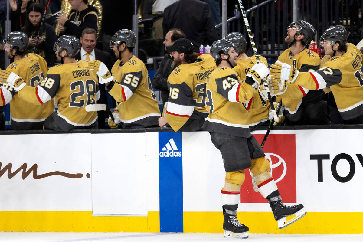 The Vegas Golden Knights bench congratulates center Paul Cotter (43) after he scored a goal aga ...