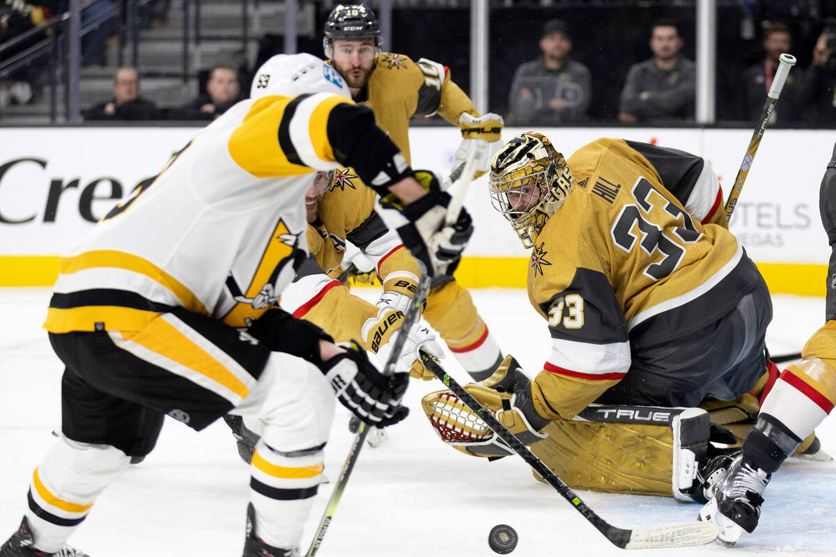 Vegas Golden Knights defenseman Alex Pietrangelo, center left, dives to block a shot by Pittsbu ...