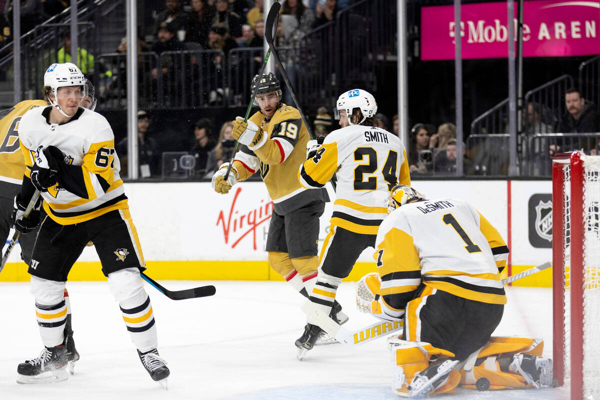 Vegas Golden Knights right wing Mark Stone, obscured at back left, scores a goal on Pittsburgh ...